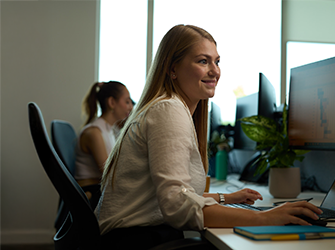 A woman smiling whilst working.